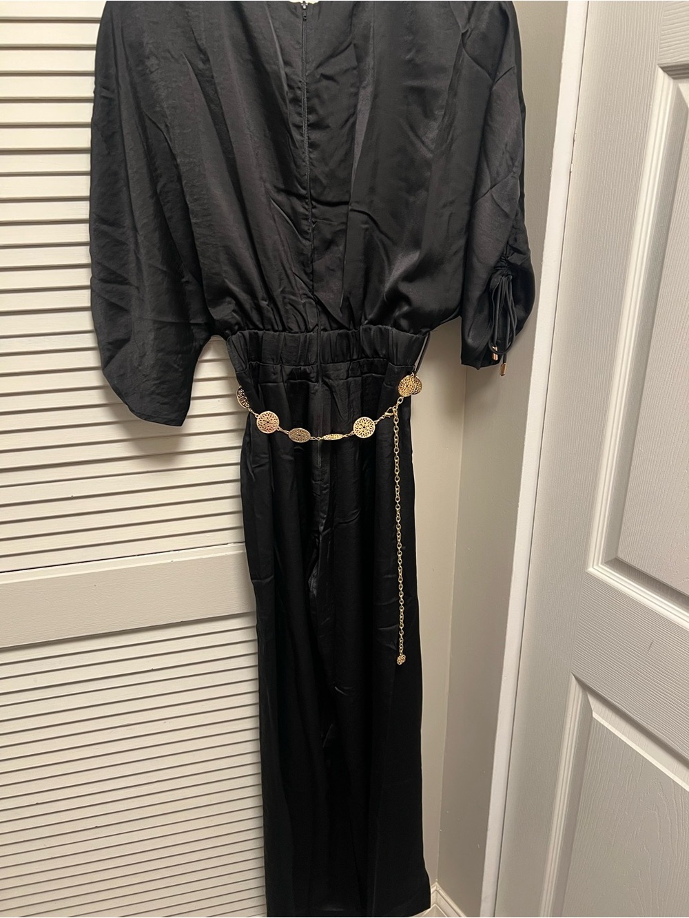 Elegant Black Jumpsuit with Decorative Gold Chain Belt